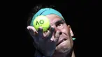 Petenis Spanyol, Rafael Nadal melakukan servis saat melawan petenis Kanada Denis, Shapovalov dalam pertandingan perempat final tunggal putra pada hari kesembilan turnamen tenis Australia Terbuka di Melbourne pada 25 Januari 2022. (AFP/Aaron Francis)