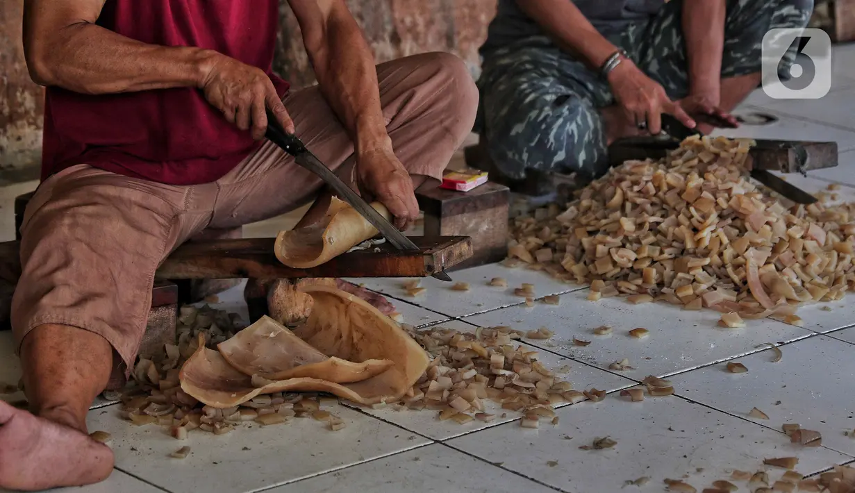 Sejumlah pekerja memotong kulit sapi di rumah produksi kerupuk kulit rumahan di Katulampa, Bogor, Jawa Barat, Sabtu (17/9/2022). Menko bidang Perekonomian, Airlangga Hartarto mengatakan, urgensi peran UMKM menjadi perhatian utama pemerintah untuk dapat memberikan dukungan bagi pelaku usaha. Salah satunya melalui akses pembiayaan KUR yang besar. (Liputan6.com/Angga Yuniar)
