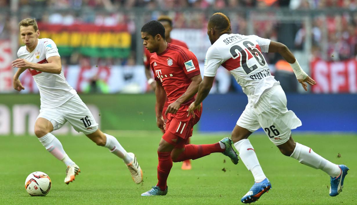 Gelandang Bayern Munchen, Douglas Costa menggiring bola melewati hadangan pemain Stuttgart, Geoffroy Serey  pada laga Bundesliga di Stadion Allianz Arena, Jerman, Sabtu (7/11/2015). (EPA/Peter Kneffel)