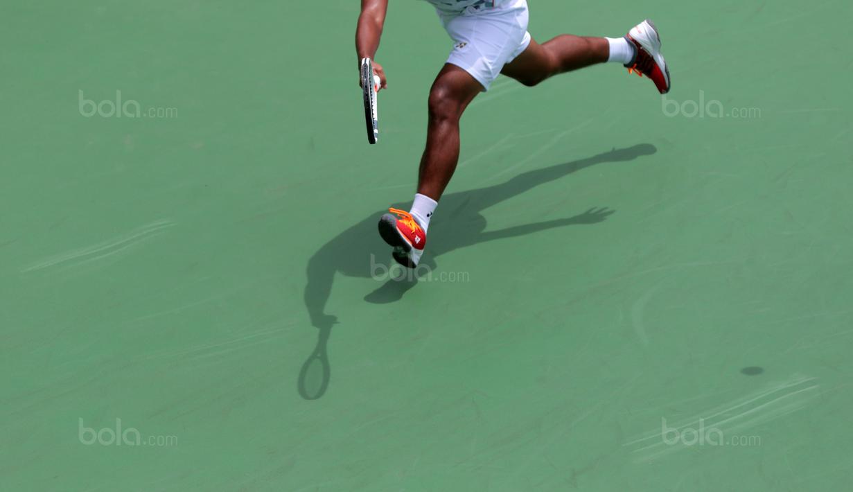 Aksi petenis Indonesia, Althaf Dhaifullah smengembalikan bola saat melawan petenis Fiipina Davis 2018 grup dua Asia/Oceania di Senayan, Jakarta, Sabtu (3/2/2018). Althaf kalah 3-6, 2-6. (Bola.com/Nick Hanoatubun)