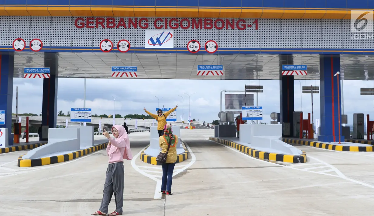 Beberapa warga berfoto berlatar gerbang tol Cigombong I di Cigombong, Kab Bogor, Jawa Barat, usai diresmikan, Sabtu (1/12). Ruas panjang tol Ciawi-Sukabumi Seksi I Ciawi-Cigombong sejauh 15,3 kilometer. (Liputan6.com/Helmi Fithriansyah)