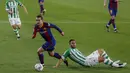 Penyerang Barcelona, Antoine Griezmann saat melewati pemain Real Betis, Victor Ruiz pada pertandingan lanjutan La Liga Spanyol di stadion Benito Villamarin di Seville, Spanyol, Senin (8/2/2021). Barcelona menang tipis atas Real Betis 3-2. (AP Photo/Miguel Morenatti)