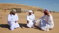 Mantan penduduk Wadi al-Murr berkumpul dekat rumah-rumah terlantar di Desa Omani, Wadi al-Murr, Oman, 31 Desember 2020. Isolasi, termasuk dari jaringan listrik dan air, berkontribusi pada lambatnya perkembangan kawasan ini. (MOHAMMED MAHJOUB/AFP)