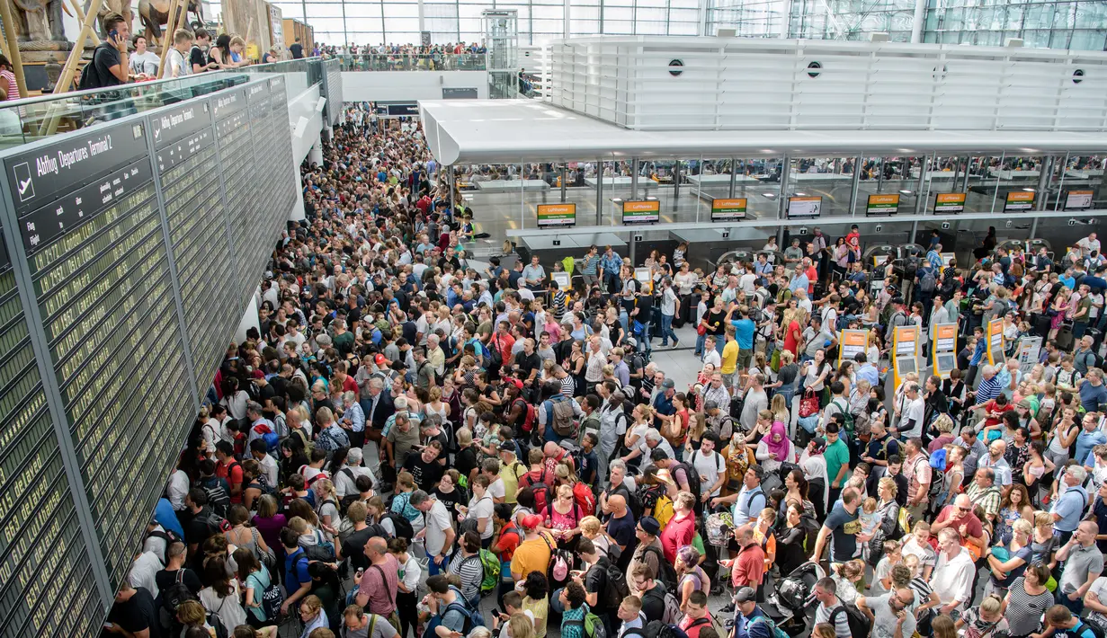 Penumpukan penumpang terjadi setelah petugas keamanan menutup sementara Terminal 2 Bandara Munich di Jerman, Sabtu (28/7). Akibat penutupan itu 200 penerbangan dibatalkan, sementara 60 penerbangan lainnya mengalami penundaan. (MATTHIAS BALK/DPA/AFP)