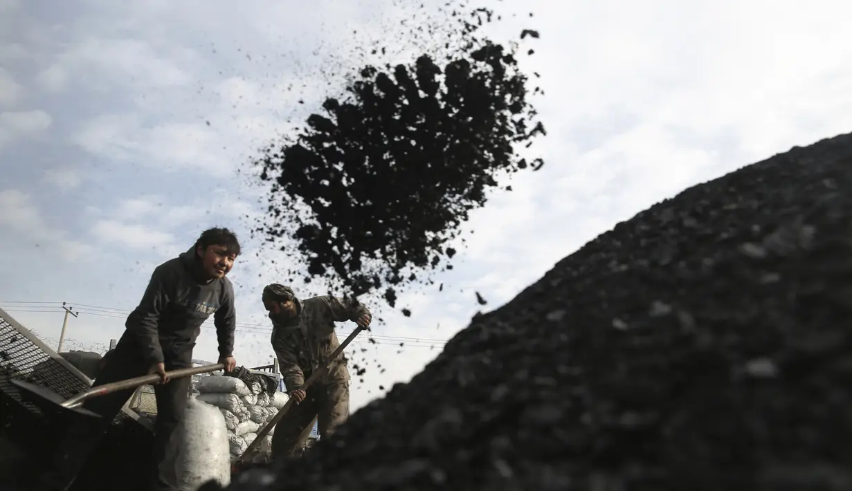 Sejumlah buruh Afghanistan bekerja di pasar arang di pinggiran Kabul, Afghanistan (18/12/2019). Di musim dingin, harga kayu dan arang naik di antara semua kebutuhan lain untuk warga Afghanistan. (AP Photo / Rahmat Gul)