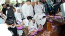 Maudy Koesnaedi didampingi suami serta sanak saudara menaburkan bunga di atas makam sang ibunda, Sondari Soemijati di TPU Karet Bivak, Jakarta, Kamis (16/4/2015). Ibunda Maudy meninggal Rabu sore (15/4) pada usia 82 ahun. (Liputan6.com/Panji Diksana)