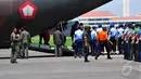 Petugas saat menurunkan empat peti jenazah korban pesawat AirAsia QZ8501 di Lanud TNI AL Juanda, Surabaya, Kamis (1/1/2015). (Liputan6.com/Johan Tallo)