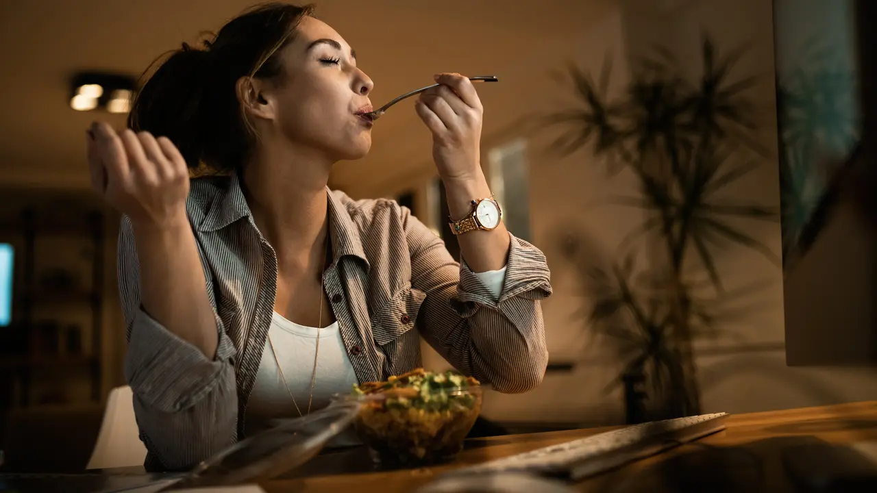 Seorang perempuan sedang menikmati makanannya di meja makan (Foto Dok: Freepik/Drazen Zigic)