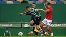 Bek Sporting Lisbon, Zou (kiri) menguasai bola dibayangi bek Benfica, Gilberto Junior dalam laga lanjutan Liga Portugal 2020/21 di Jose Avalade Stadium, Lisbon, Senin (1/2/20201). Sporting menang 1-0 atas Benfica. (AFP/Patricia De Melo Moreira)
