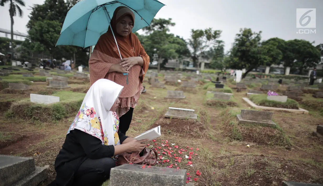 Sejumlah warga berdoa di makam keluarga saat ziarah kubur di Tempat Pemakaman Umum (TPU) Menteng Pulo, Jakarta, Minggu (28/4/2019). Tradisi ziarah kubur dilakukan umat Muslim menjelang datangnya bulan suci Ramadan untuk mendoakan keluarga mereka yang telah wafat. (Liputan6.com/Faizal Fanani)