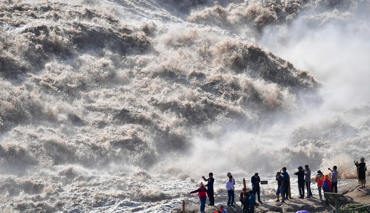 Para turis memotret Air Terjun Hukou di Sungai Kuning dari sebuah lokasi wisata di Wilayah Yichuan, Provinsi Shaanxi, China barat laut, pada 11 September 2020. (Xinhua/Shao Rui)