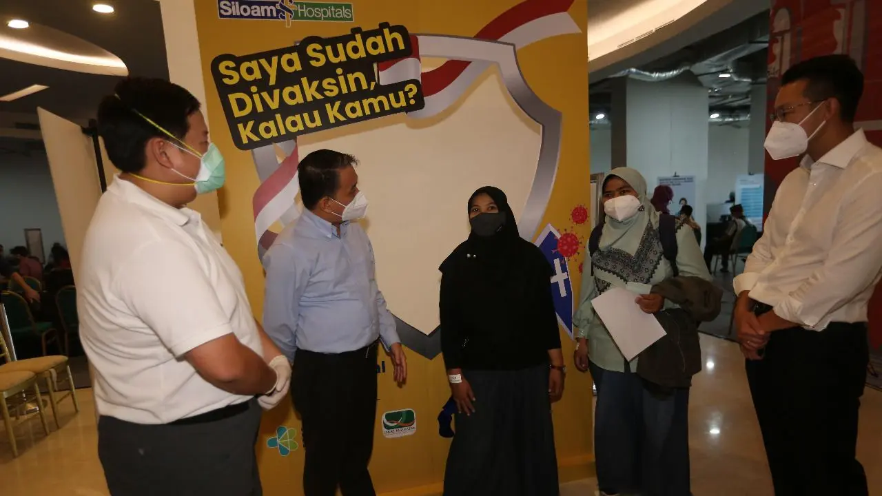 CEO Lippo Karawaci John Riady (kanan) bersama Perwakilan Lippo Malls Indonesia Henry Riady (kiri), CEO Lippo Malls Indonesia Eddy Mumin (kedua kiri) berbincang dengan guru yang mengikuti vaksinasi di Lippo Mall Kemang, Jakarta.