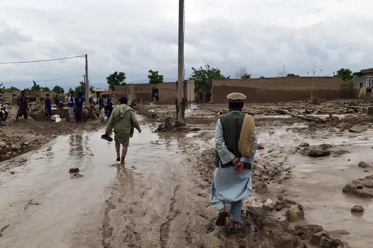 Warga berada di dekat rumah mereka yang rusak setelah banjir besar di Provinsi Baghlan, Afghanistan, pada Sabtu (11/5/2024).