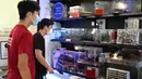 Orang-orang melihat tampilan formicarium yang menampung semut di dalam toko "Just Ants" di Singapura pada 23 September 2020. Peternakan semut lebih umum di beberapa negara Barat, namun jarang terjadi di Singapura dan John Ye mencoba mengubah konotasi negatif terkait serangga. (Roslan RAHMAN/AFP)