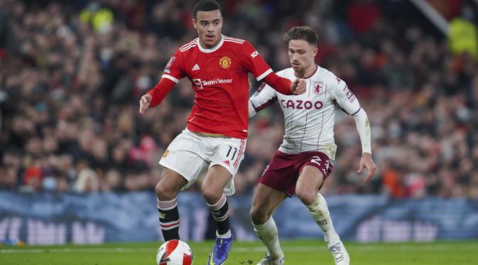 Gelandang Manchester United, Mason Greenwood mengontrol bola dari kawalan gelandang Aston Villa, Matty Cash pada pertandingan putaran ketiga Piala FA di stadion Old Trafford, Inggris, Selasa (11/1/2022). Berkat hasil ini, MU berhak lolos ke putaran keempat. (AP Photo/Jon Super)