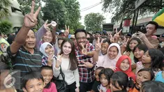 Calon wakil gubernur DKI Jakarta Djarot Saiful Hidayat berfoto bersama warga saat blusukan di Pasar Bedeng, Palmerah, Jakarta Barat, Kamis (24/11). Dalam blusukannya, Djarot berdialog dengan pedagang dan warga di pasar. (Liputan6.com/Yoppy Renato)