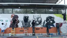 Sejumlah seniman grafiti membuat mural harimau kumbang di Bangkok, Thailand (16/3). Aksi ini sebagai protes perburuan liar ilegal oleh konglomerat konstruksi Premchai Karnasuta. (AFP Photo/Lillian Suwanrumpha)