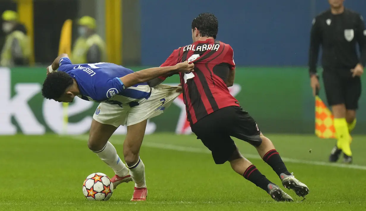 Penyerang FC Porto, Luis Diaz berebut bola dengan bek AC Milan Davide Calabria  pada matchday kelima Grup B Liga Champions di San Siro, Kamis (4/11/2021) dini hari WIB. AC Milan  makin terpuruk setelah hanya mampu bermain imbang dengan Porto 1-1. (AP Photo/Luca Bruno)