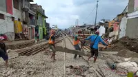 Beberapa petugas nampak sibuk melakukan pengerajaan pemindahan bantalan rel, di sekitar Stasiun Garut Kota, Garut, Jawa Barat, dalam tahap akhir progres reaktivasi kereta api Garut. (Liputan6.com/Jayadi Supriadin)