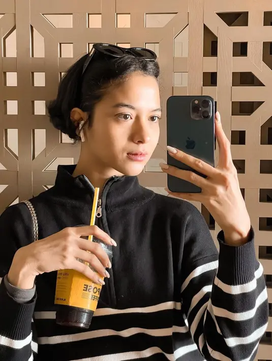 Kali ini, Putri memilih sweater garis-garis dengan aksen zipper di bagian depan.  [@putrimarino]