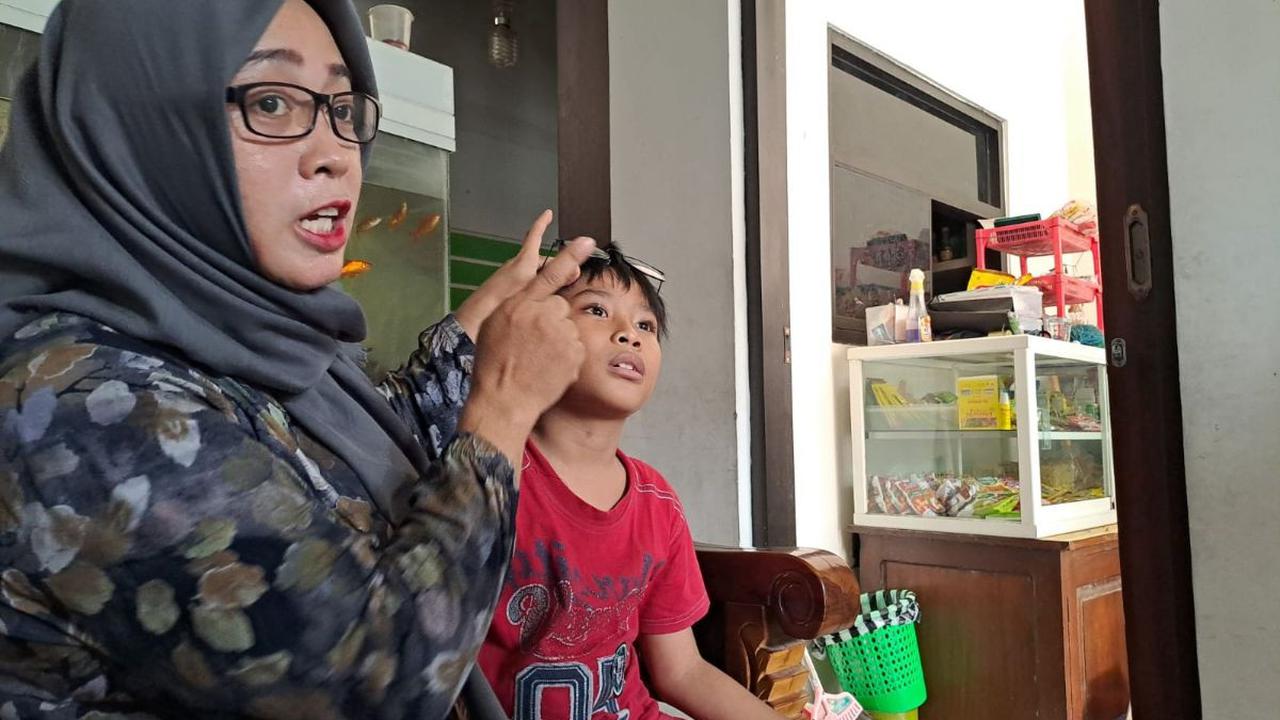 Ada yang bermain kartu dan juga bermain bola di dalam kelas.