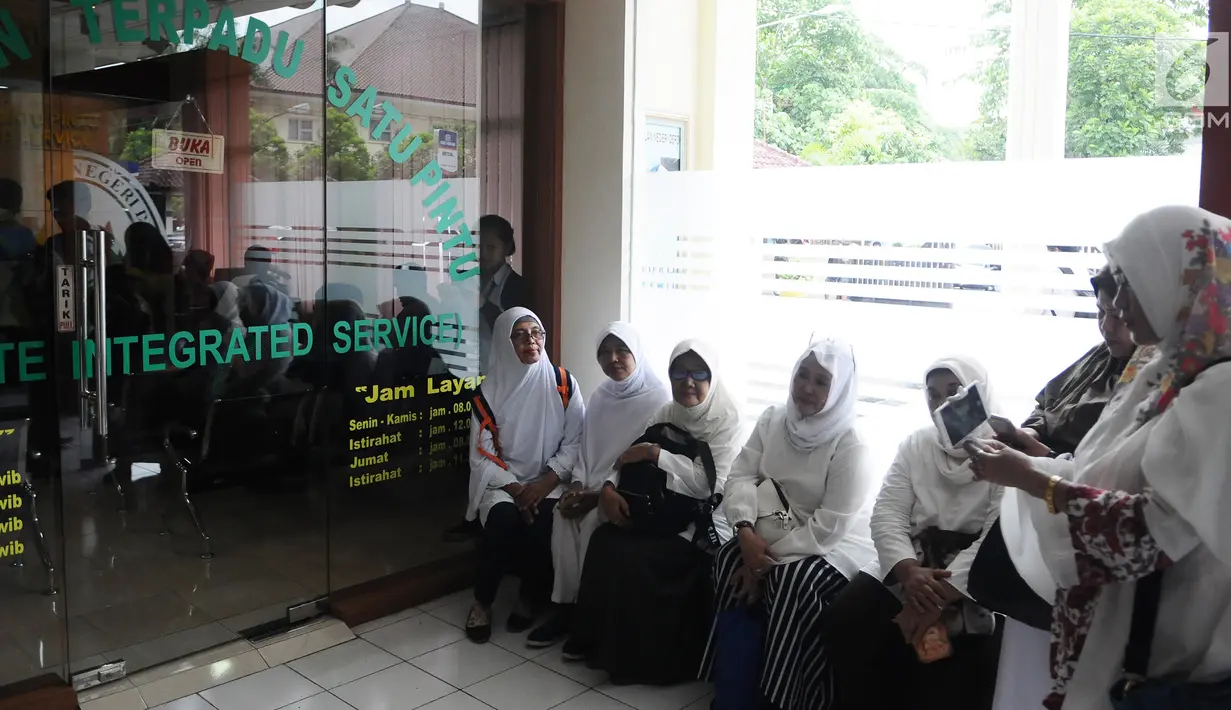 Jemaah korban First Travel menunggu kuasa hukum mereka mendaftarkan gugatan di Pengadilan Negeri Depok, Jawa Barat, Senin (4/3). Para korban mengajukan gugatan perdata untuk aset First Travel. (Liputan6.com/Herman Zakharia)