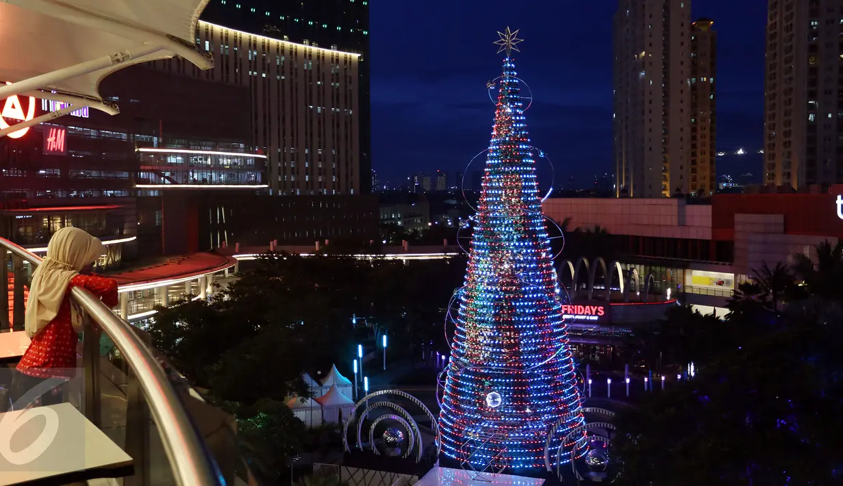 Pengunjung melihat pohon natal di Mal Central Park yang mendesain dengan ornamen Natal, Jakarta  Rabu (21/12). Jelang perayaan natal sejumlah mal di Jakarta mendekor mal bernuansa natal agar menjadi daya tarik pengunjung. (Liputan6.com/Johan Tallo)