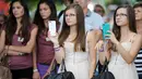 Para anak kembar berpose di festival Fete des Jumeaux di Pleucadeuc, Prancis, Jumat (15/8/14). (AFP PHOTO/Fred TANNEAU) 