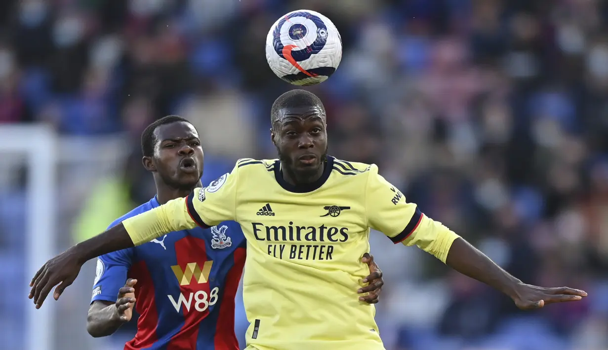 Penyerang Arsenal, Nicolas Pepe berebut bola dengan bek Crystal Palace, Tyrick Mitchell  pada pekan ke-37 Liga Inggris, Kamis (20/5/2021) dini hari WIB. The Gunners -julukan Arsenal- menang dengan skor 3-1 di markas Crystal Palace. (Justin Setterfield/Pool Photo via AP)