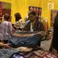 Pengunjung melihat kain selama pameran Karya Kreatif Indonesia (KKI) di Jakarta, Jumat (12/7/2019). Pameran KKI 2019 ini berlangsung selama 3 hari menampilkan produk-produk UMKM RI mulai dari kain, pakaian, tas, hingga berbagai kuliner seperti kopi buatan anak negeri. (Liputan6.com/Angga Yuniar)