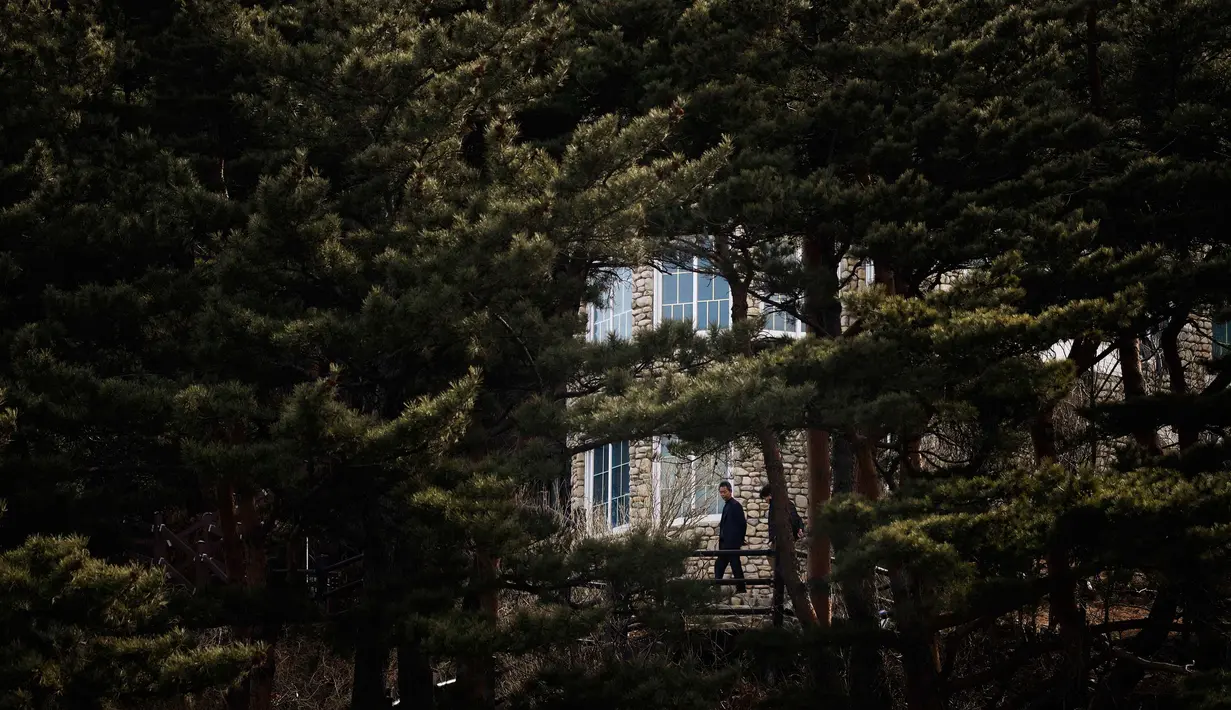 Pengunjung berdiri di luar vila yang dikenal sebagai Kastil Hwajinpodi di Pantai Hwajinpo, Korea Selatan, (19/2). Villa ini merupakan tempat liburan mendiang pendiri Korea Utara Kim Il Sung. (AP Photo/Jae C. Hong)