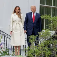 Presiden AS Donald Trump dan ibu negara Melania Trump menuruni tangga untuk menyaksikan White House Egg Roll di&nbsp;halaman selatan&nbsp;Gedung Putih di Washington, DC., dalam rangka perayaan Paskah, 21 April 2025. (Anna Moneymaker/Getty Images/AFP)