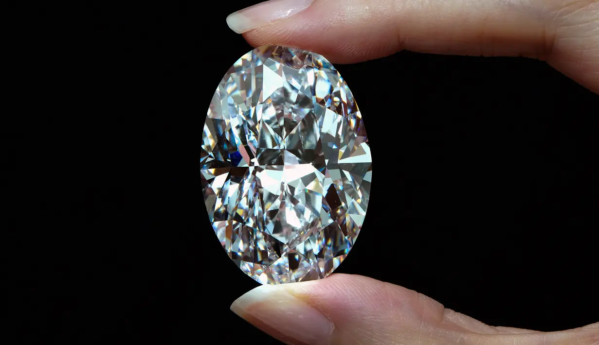 Berlian putih 102,39 karat, yang dikenal sebagai warna D, tanpa cela dipamerkan seorang model di ruang lelang Sotheby di Hong Kong, Senin (28/9/2020). Berlian yang ukurannya seperti telur atau permen lolipop besar itu akan dilelang di Sotheby's di Hong Kong pada 5 Oktober. (AP Photo/Vincent Yu)