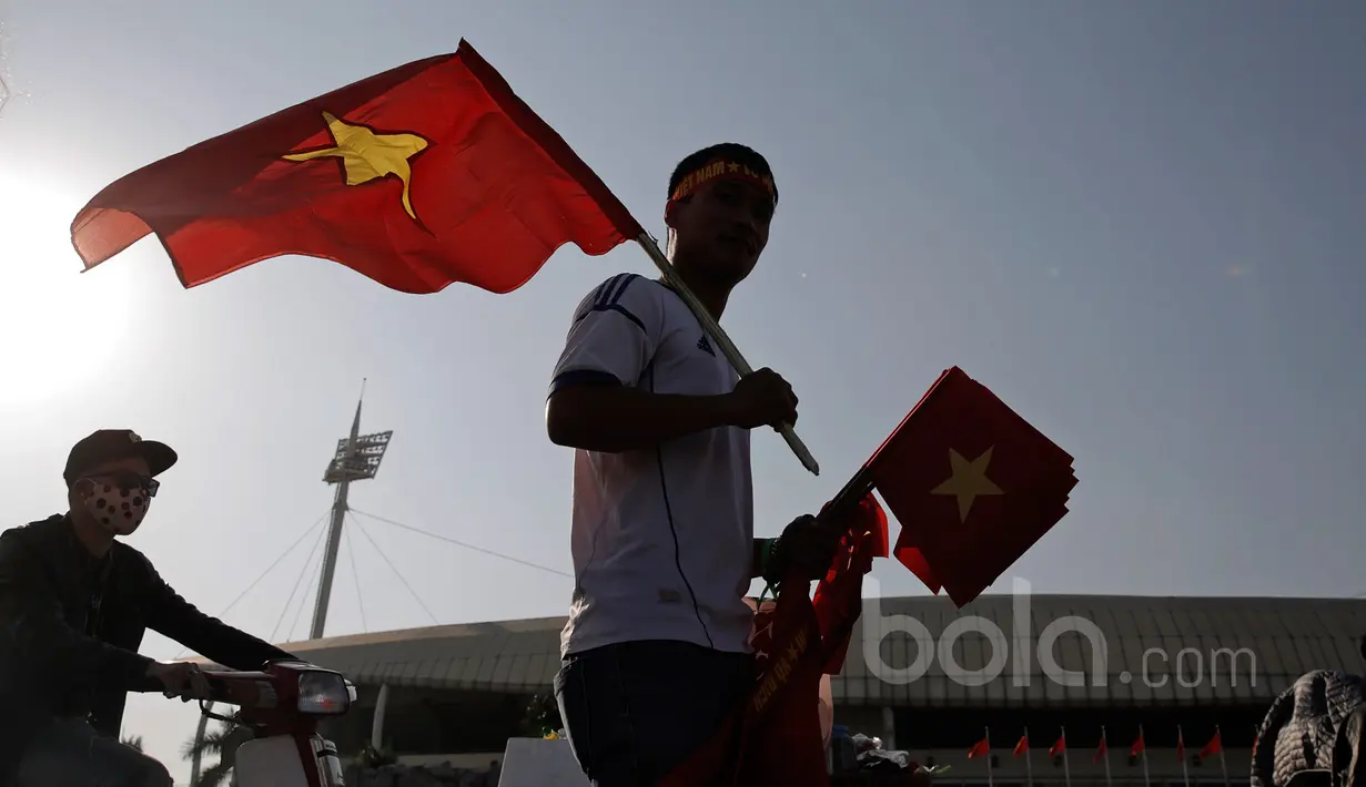 Fans Vietnam siap membagikan bendera kepada pendukung sebelum laga semifinal Piala AFF 2016 di Stadion Nasional My Dinh, (07/12/2016). (Bola.com/Peksi Cahyo)