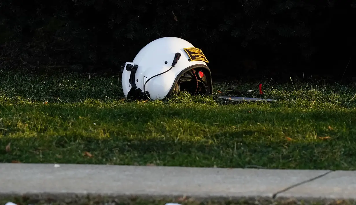 Sebuah helm tergeletak di tanah dekat lokasi helikopter medis yang jatuh di dekat Gereja Drexel Hill United Methodist Church di Drexel Hill, Philadelphia, Pennsylvania, AS (11/1/2022). Helikopter medis yang akan menuju keluar negara AS terjatuh di dekat gereja. (AP Photo/Matt Rourke)