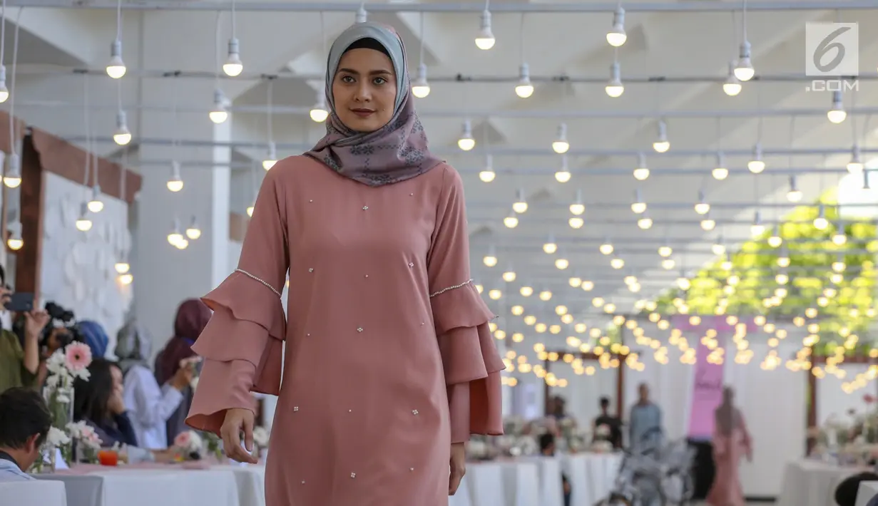 Model membawakan busana karya desainer Intan Kusuma dan Atina Maulia di Akuatik GBK Senayan, Jakarta, Kamis (2/5/2019). Sebanyak 30 koleksi busana hijab mulai dari dress, blouse tunik dan hijab dipamerkan menyambut bulan suci Ramadan. (Liputan6.com/Fery Pradolo)