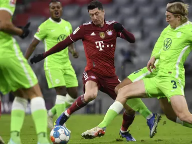 Mesin Gol Bayern Munchen itu membukukan gol terakhir Die Roten di tiga menit terakhir pada laga melawan Wolfsburg di Allianz Arena. (AP Photo/Andreas Schaad)