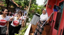 Relawan dari Gerakan Aksi Srikandi Coblos Ahok (Gadis Ahok) memberikan sapu dan tempat sampah ke warga di kawasan Cipete, Jakarta Selatan, Senin (26/12). Sebanyak 150an kantong sampah dan sapu dibagikan ke warga. (Liputan6.com/Gempur M Surya)