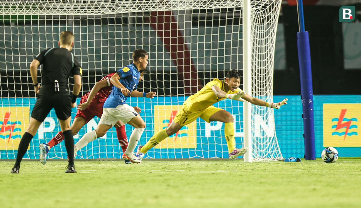 Kiper Timnas Indonesia U-17, Ikram Algiffari berusaha mengamankan bola dari ancaman pemain Timnas Ekuador U-17, Erick Zambrano (tengah) pada laga pertama Grup A Piala Dunia U-17 2023 di Stadion Gelora Bung Tomo, Surabaya, Jumat (10/11/2023). (Bola.com/Bagaskara Lazuardi)