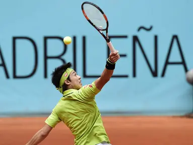 Petenis Jepang, Kei Nishikori berusaha mengmbalikan bola saat melawan petenis Prancis, Richard Gasquet pada ajang Madrid Open tournament di Caja Magica (Magic Box),  Madrid, Kamis (5/5/2016). (AFP/Javier Soriano)