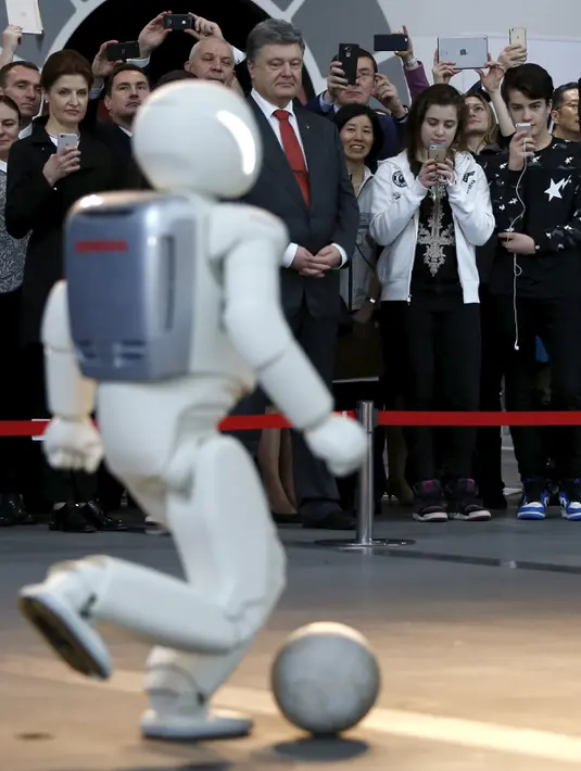 Robot humanoid buatan Honda motors Asimo saat beraksi bermain bola di Miraikan, Tokyo , Jepang , (7/4). Miraikan adalah Museum Nasional Sains dan Inovasi yang ada di Jepang. (REUTERS / Issei Kato)