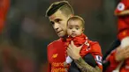 Gelandang Liverpool Philippe Coutinho menggendong putrinya saat salam penghormatan usai berakhirnya pertandingan melawan Chelsea pada pertandingan Liga Inggris di Anfield, Liverpool, 12 Mei 2016. (Reuters / Andrew Yates)