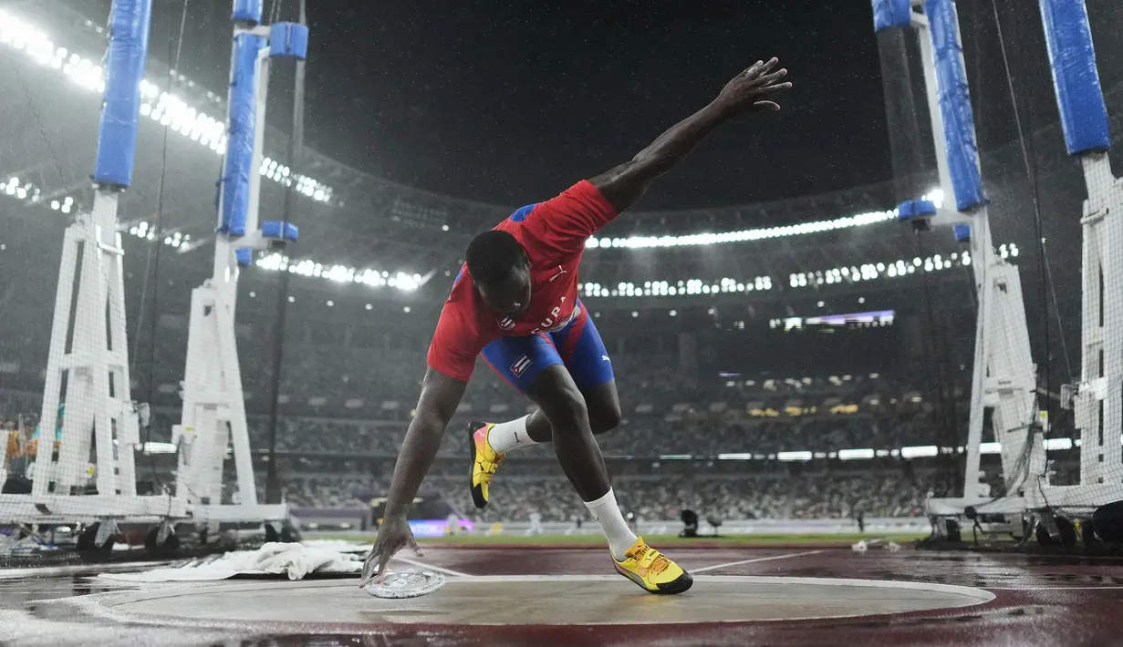 Atlet Kuba, Mario Alberto Diaz terpeleset saat final lempar cakram putra dalam ajang Kejuaraan Dunia Atletik 2025 di Tokyo, Jepang, Minggu (21/09/2025). (AP Photo/Bernat Armangue)