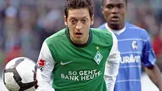 Aksi gelandang Werder Bremen Mesut Oezil (depan) dibayangi striker Freiburg Cedric Makiadi di laga lanjutan Bundesliga yang berlangsung di Bremen, 10 April 2010. Werder unggul 4-0. AFP PHOTO DDP / PHILIPP GUELLAND