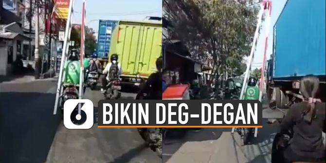 VIDEO: Bikin Deg-Degan, Ojol Bawa Tangga Salip Truk Kontainer