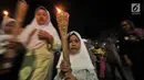 Seorang anak membawa obor saat pawai Tahun Baru Islam 1440 H di Menteng, Jakarta, Senin (10/9). Pawai obor yang diiringi musik bernuansa Islam merupakan tradisi umat muslim di Indonesia menyambut Tahun Baru 1 Muharram. (Merdeka.com/Iqbal S Nugroho)