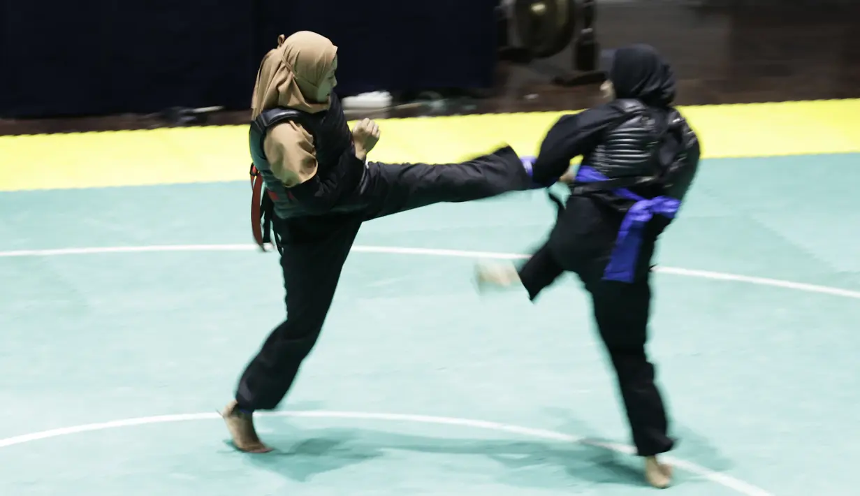 Pendekar Pagar Nusa saat bertarung dalam Kejurnas dan Festival III Pencak Silat di Padepokan Pencak Silat, TMII, Jakarta, Sabtu (4/1). Kejuaraan ini diikuti ratusan pendekar silat Pagar Nusa dari seluruh Indonesia. (Bola.com/Yoppy Renato)