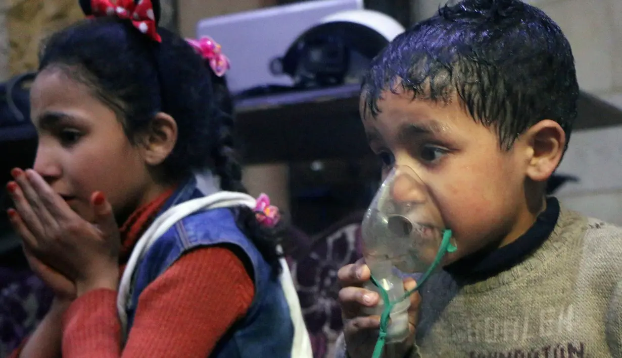 Anak-anak menghirup oksigen setelah diduga terkena serangan senjata kimia di Kota Douma, dekat Damaskus, Suriah, Minggu (8/4). Douma merupakan kota yang dikuasai oleh oposisi. (Syrian Civil Defense White Helmets via AP)