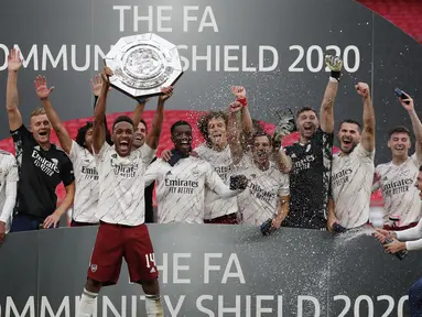 Pemain Arsenal mengangkat trofi Community Shield 2020 usai mengalahkan Liverpool di Stadion Wembley, Sabtu (29/8/2020) malam WIB. Arsenal menang 5-4 atas Liverpool lewat adu penalti. (Andrew Couldridge/Pool via AP)