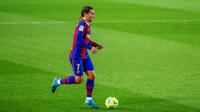 Penyerang Barcelona, Antoine Griezmann, menggiring bola saat melawan Real Sociedad pada laga Liga Spanyol di Stadion Camp Nou, Kamis (17/12/2020). Barcelona menang dengan skor 2-1. (AP/Joan Monfort)